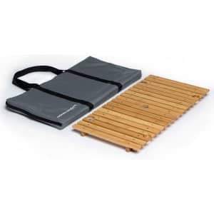 A foldable wooden table in natural colour, accompanied by a grey carrying bag with handles.