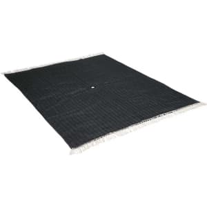 A dark green picnic blanket with a textured surface and white fringes along the edges. It features a central hole.