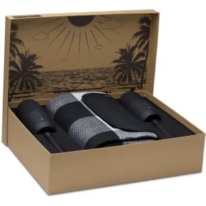 A boxed set featuring two black speaker-like devices and a grey striped rug, with a beach-themed design inside the box.