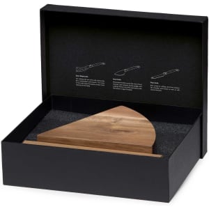 A wedge-shaped wooden cheese knife block set in a black box, featuring a textured interior and a branding logo.