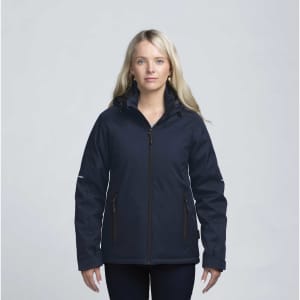 A woman wearing a navy soft shell jacket with a hood and zippered pockets, featuring a logo on the sleeve.