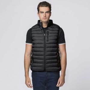 A black puffer vest with a high collar and zippered pockets, worn by a model. The vest features a logo.