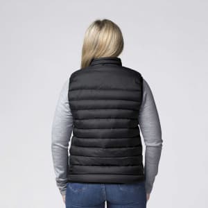 A black padded baffle vest seen from the back, worn over a grey long-sleeve top, featuring a logo.