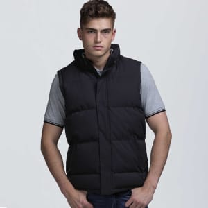 A male model wearing a black puffa vest over a grey shirt, featuring a hood and a sleek design.
