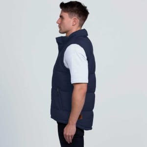 A navy puffa vest shown from the side, featuring a high collar and a logo on the front.