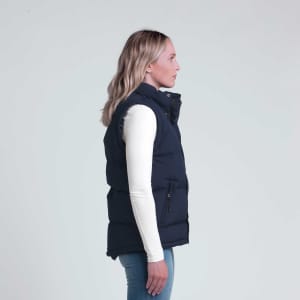 A navy puffer vest displayed on a model, featuring a high collar and zippered pockets.