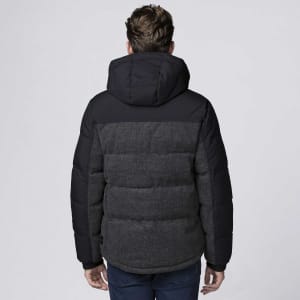 A rain jacket in black and dark grey, featuring a hood and a puffy design, with a logo visible on the garment.