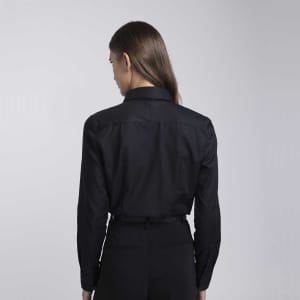 A black button-up shirt with a tailored back design and long sleeves, featuring a logo.