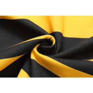 A close-up of folded fabric featuring bold black and yellow stripes, showcasing its texture and pattern.