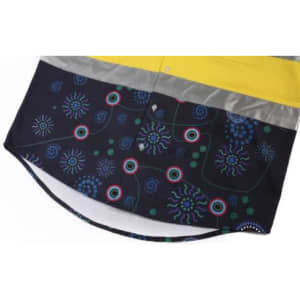 A Hawaiian shirt featuring a dark print with colourful patterns and a yellow reflective strip. It has a logo.
