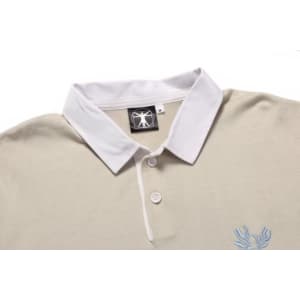 A beige sports jumper featuring a white collar and a logo. It has three buttons at the neck and embroidered detail.
