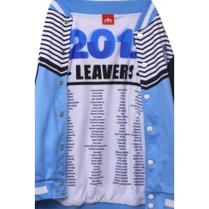 A blue sports jumper featuring a striped design and a list of names inside. It has a logo on the exterior.