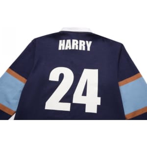 A navy sports jumper featuring brown and light blue stripes with a large white number 24 and a name.