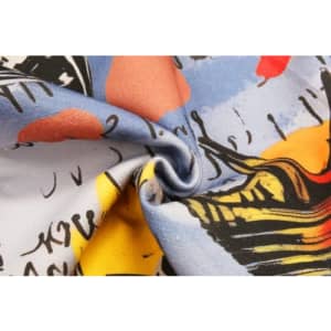 A patterned fabric with vibrant colours, featuring abstract designs in blue, yellow, red, and black.