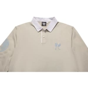 A beige sports jumper featuring a white collar and an embroidered design, complete with a logo on the sleeve.