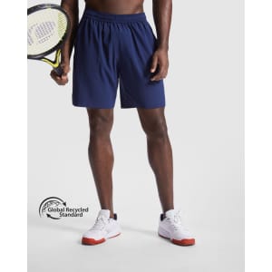 Navy sports shorts with an elastic waistband, held by a person holding a tennis racket. Features a logo.