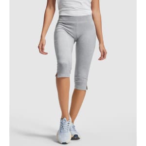 Mid-length grey leggings with a fitted design and side slits, paired with a white top and blue athletic shoes.