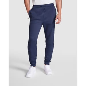 Navy track pants with a tapered fit and elastic waistband, featured with side pockets and a logo.