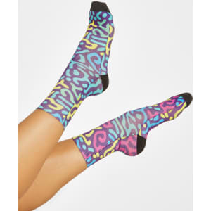 Colourful patterned socks featuring blue, yellow, and pink designs with black accents and a logo.