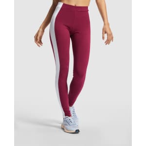 Maroon leggings with white side panels, featuring a fitted style and a branding logo.