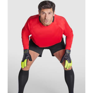 A sporty long-sleeved red t-shirt worn by a goalkeeper, paired with black shorts and gloves.