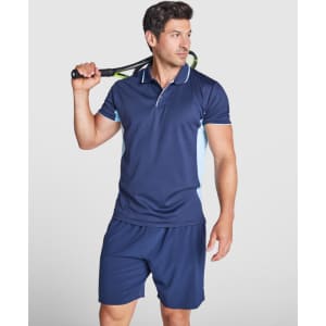 A navy blue polo shirt with light blue accents, worn by a man holding a tennis racquet.