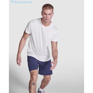 A white Estoril T-Shirt displayed on a model wearing navy shorts. The shirt features a logo.