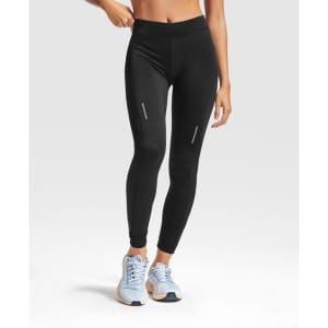 Black leggings with a fitted design, featuring reflective details, paired with light blue sneakers.