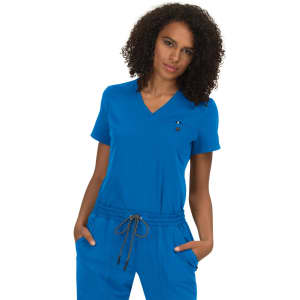 A woman is wearing a vibrant blue top with a V-neck and short sleeves, featuring a logo.