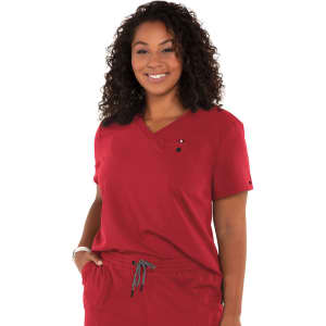 A woman wearing a red scrub top with a V-neck and a pocket, featuring a small logo on the chest.