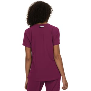 A purple top with short sleeves, designed with a logo on the back. The fabric appears lightweight and relaxed.