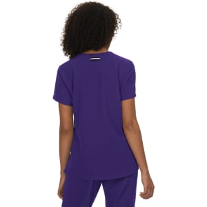 A purple top with short sleeves and a logo on the back, featuring a simple and stylish design.