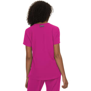 A pink top with a simple design and a logo on the back, featuring a relaxed fit and short sleeves.