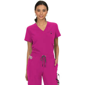 A woman wearing a vibrant pink top with a V-neck and pockets, featuring a small logo.