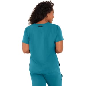 A teal work top with short sleeves, featuring a subtle logo on the back.