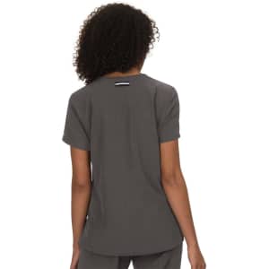 A grey top with short sleeves and a back detail. The garment has a logo on it.