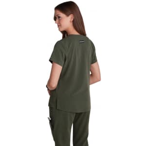 A woman wearing a dark green, short-sleeved top, viewed from the back. The top has a logo on the back.