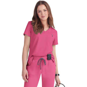 A pink "Ready to Work Top" with a V-neck design, worn with matching pink pants, featuring a logo.