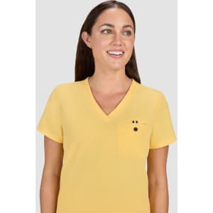 A yellow v-neck top with short sleeves and a small pocket, worn by a woman with long brown hair.