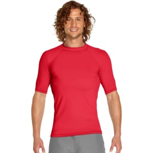 A red adult short sleeve rashie featuring UPF 50+ protection, displayed on a male model with curly hair.