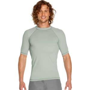 A short sleeve rashie in a soft green hue featuring a fitted style and a logo. Ideal for sun protection with UPF 50+.