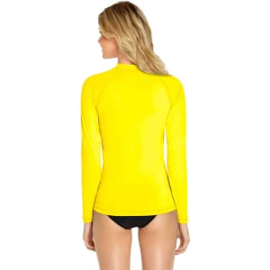 A yellow long sleeve rashie with a high collar, featuring a fitted design and a logo on the back.