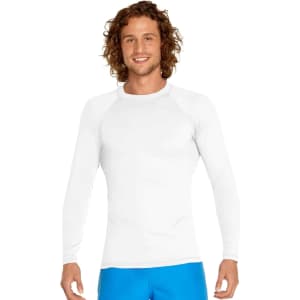 A white long sleeve rashie featuring UPF 50+ protection, worn by a model with curly hair.
