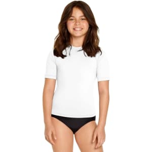 A white youth short sleeve rashie UPF 50+ featuring a crew neck, modelled by a smiling child.