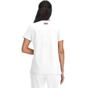 A white top with a simple design, featuring a back yoke detail and a small logo.