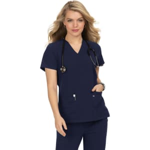 A navy blue scrubs top featuring a V-neck design, with two pockets, worn by a model holding a stethoscope.