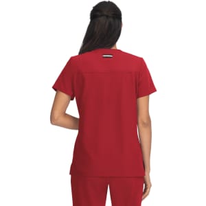 A red medical top with short sleeves and a back seam detail, featuring a branding logo.