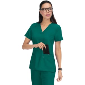 A model wears a green scrub top with short sleeves and a v-neck, featuring pockets and a logo.