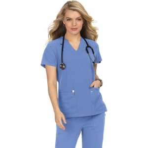 A woman wearing a light blue medical top with short sleeves, featuring two front pockets and a stethoscope around her neck.