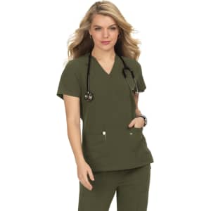 A model wearing an olive green top with a V-neck and a stethoscope, featuring front pockets and a logo.